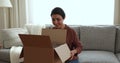 Glad Indian female addressee get parcel unpack delivery look inside