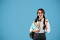 Glad inspired caucasian teen girl with pigtails in glasses with headphones student with backpack