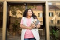 Glad Latin Young Woman Holding Workbooks And Digital Tablet Outdoor