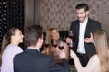 Glad man pronouncing toast in cozy restaurant Royalty Free Stock Photo