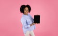 Glad millennial african american curly pregnant woman with belly show tablet with blank screen