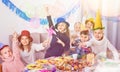 Boys and girls behaving jokingly during friend birthday party