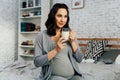 Pregnant mixed race woman drinking milk