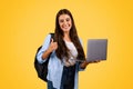 Glad pretty caucasian young student lady use laptop, show thumb up gesture