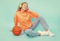 glad redhead basketball woman player on color background. basketball woman player