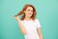 glad redhead girl with curly hair on blue background