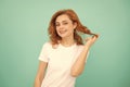 glad redhead girl with curly hair on blue background