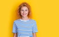 glad redhead girl portrait isolated on yellow background. portrait of young redhead girl in studio.