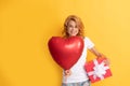 glad redhead lady with romantic gift and party balloon. happy valentines day