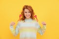 glad redhead woman with red heart sticks on yellow background. valentines day