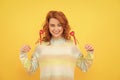 glad redhead woman with red heart sticks on yellow background. valentines day