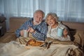 Glad senior couple having meal in bedroom Royalty Free Stock Photo