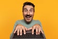 Glad shocked funny senior european man typing on keyboard laptop, with open mouth