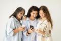 Glad shocked millennial, senior women and teen girl enjoy chat on phone, have fun