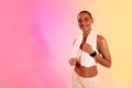 Glad slim sweat young latin lady athlete in sportswear and towel on neon pink studio background