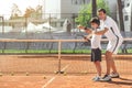 Glad smiling family playing tennis