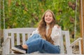 glad teen girl having free time outside on swing, playground Royalty Free Stock Photo