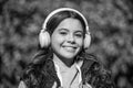 glad teen girl listening music wearing headphones. photo of teen girl listening music. Royalty Free Stock Photo