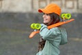 glad teen kid skater with skateboard outdoor. girl with penny board. hipster girl with longboard
