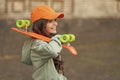 glad teen kid skater with skateboard outdoor. girl with penny board. hipster girl with longboard