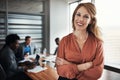 Glad to be leading the best team in business. Portrait of a confident young businesswoman standing in an office with her Royalty Free Stock Photo