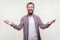 Glad to see you! Portrait of kind generous bearded man raising hands in gesture welcome. white background