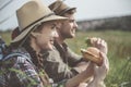 Glad tourists having rest on field Royalty Free Stock Photo