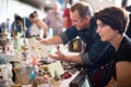 Glad tourists study the range of flea market Royalty Free Stock Photo