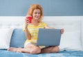 glad woman freelancer with coffee work at home on laptop. freelancer woman work at home.