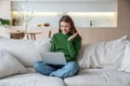 Glad woman looking at notebook screen, having video online conversation with friends, relatives