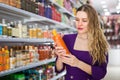 Glad young female choosing hair care products Royalty Free Stock Photo