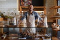 Glad youve decided to make a delicious start your day. Portrait of a young business owner standing behind the counter of