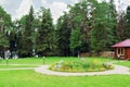 Glade with cobbled paving paths and beautiful flower bed Royalty Free Stock Photo