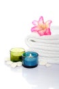 Gladiola, towel, candles and river stones Royalty Free Stock Photo