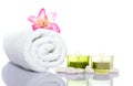 Gladiola,white towel,candles and white river stones Royalty Free Stock Photo