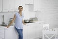 Gladsome woman smiling in her kitchen stock photo