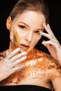 Glamorous blonde girl with professional makeup and gold foil on Royalty Free Stock Photo