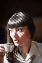 Glamorous brunette holding teacup