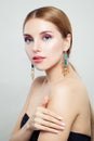 Glamorous fashion model with colorful makeup and gold earrings, portrait Royalty Free Stock Photo