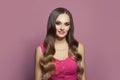 Glamorous fashion model woman with long healthy hair and clear skin on pink background Royalty Free Stock Photo