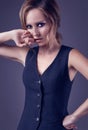 Seductive blonde girl in pants and a man`s waistcoat Royalty Free Stock Photo