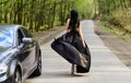 Glamorous girl and luxury car. Escort and sexual services. Driver girl. Beauty and fashion. Woman in black dress Royalty Free Stock Photo