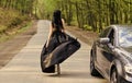 Glamorous girl and luxury car. Escort and sexual services. Driver girl. Beauty and fashion. Woman in black dress