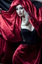 Glamorous girl in red robe