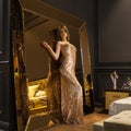 Glamorous interior golden mirror. Fashion Beautiful young woman