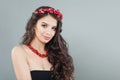 Glamorous model woman with curly hair and coral jewelry