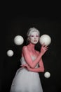 Glamorous model woman with white planet spheres on black background. Astrology, magic, fantastic and space concept Royalty Free Stock Photo