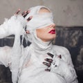 Glamorous mummy. Portrait of a young beautiful woman in bandages all over her body. Royalty Free Stock Photo