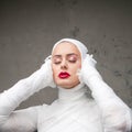 Glamorous mummy. Portrait of a young beautiful woman in bandages all over her body. Royalty Free Stock Photo