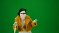 Glamorous mummy posing in an orange fur coat, hat and sunglasses. Green screen isolated chroma key. Mock up, workspace